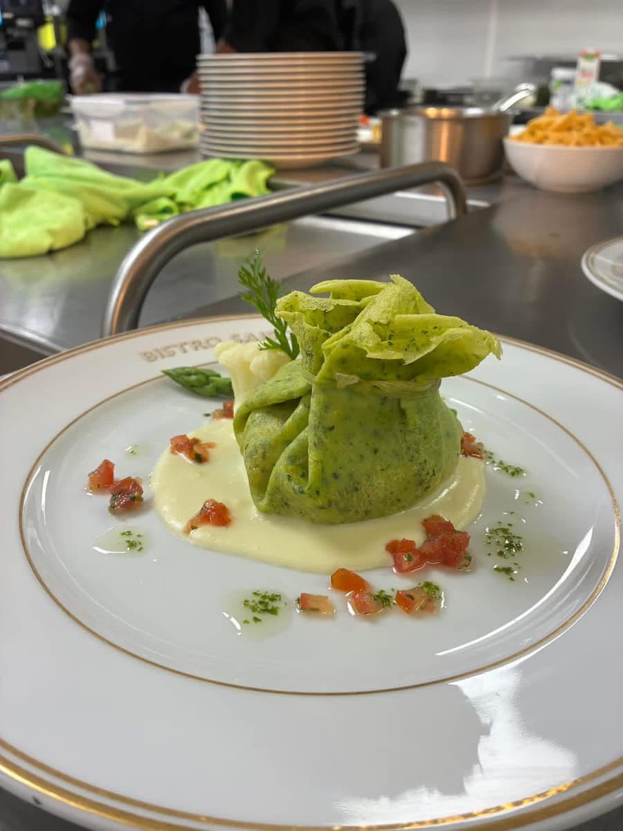 A partner chef plating a dish