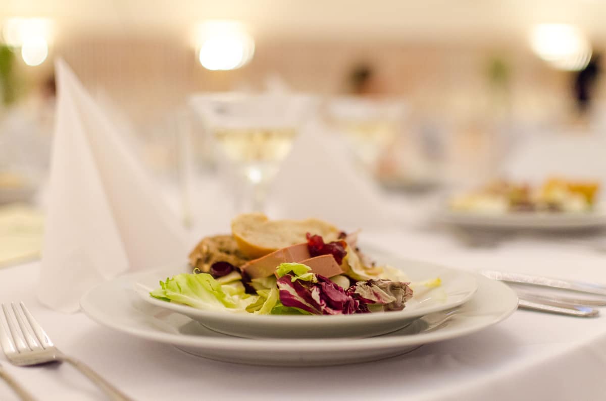 Plated course on a dressed dinner table